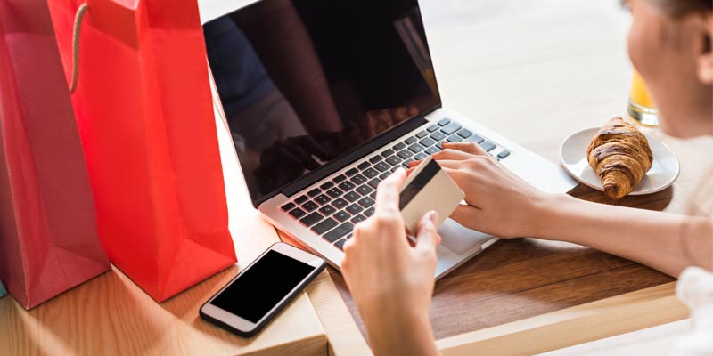 10 Best E-Commerce Platforms. Women make e-shoping on a cafe.